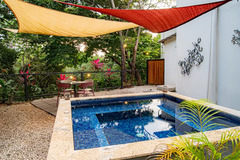 The private plunge pool at Villa Luna, framed by sun shades and tropical garden