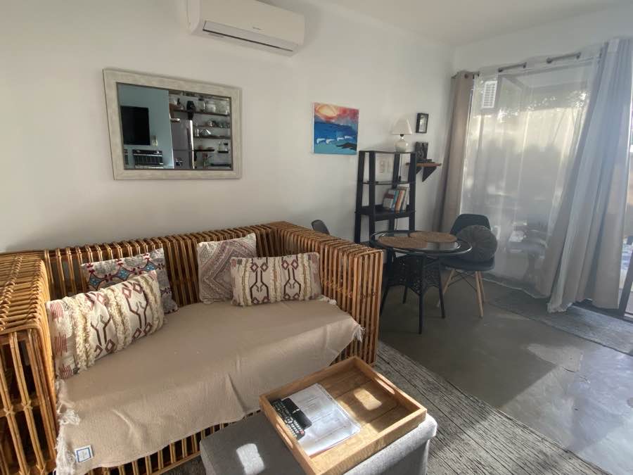 The rattan sofa and dining nook in the Casa Luna living room