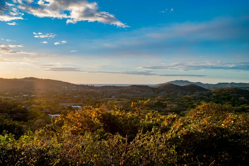 The panoramic view from Villa Toltec — rolling hills out to the ocean at dusk