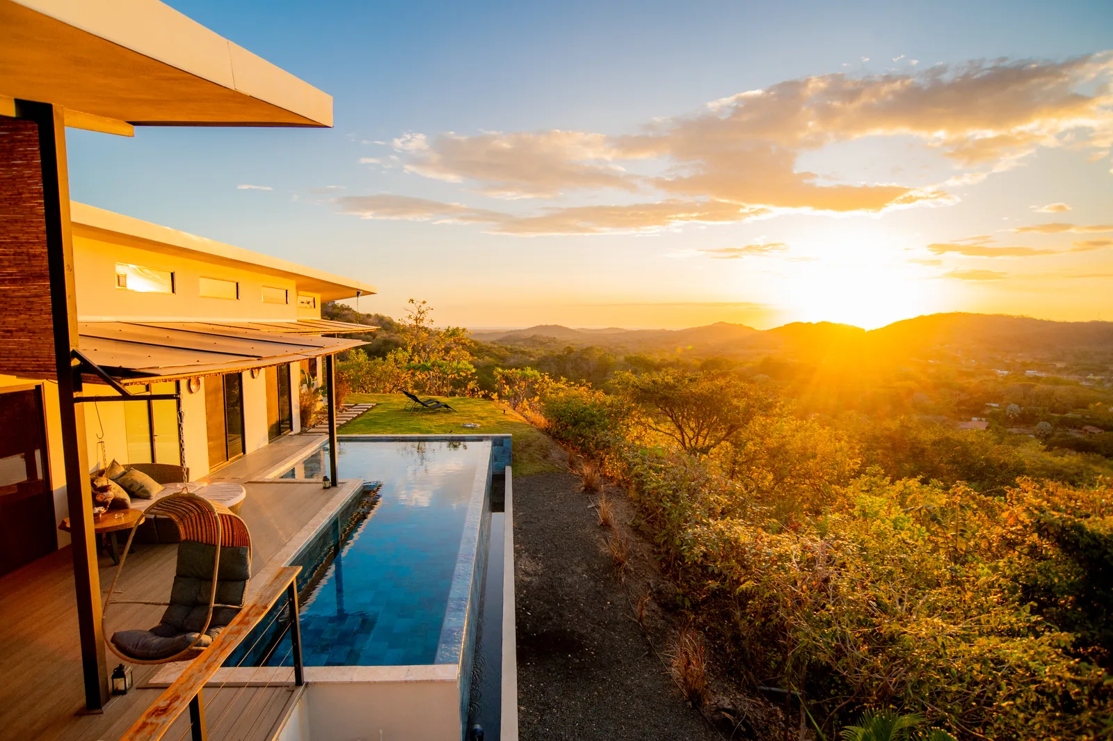 Sunset over the infinity pool, deck, and hills at Villa Toltec
